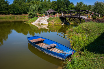 Old blue vintage wooden boat in a lake