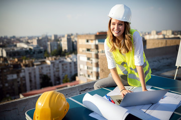 Young woman architect, construction engineer at a construction site