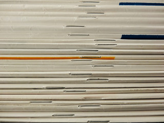 Stack of magazines closely focused with staples. Texture