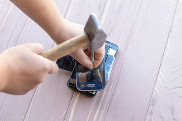 daylight. hammer hit on the phones. in one of them there is a metal nail