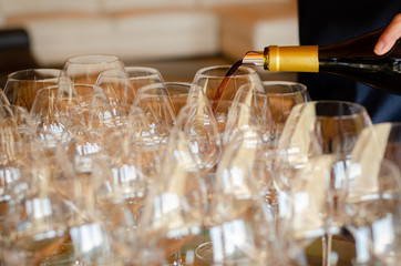 Elegant empty row of wine glasses.Many empty glass on bar ready to fill wine.clean glasses in restaurant.glasses on counter in bar. Selective focus.ready for party, drink, vacation and celebration