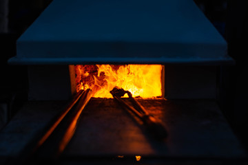 Flames blazing in a glass furnace. next tool. - obrazy, fototapety, plakaty
