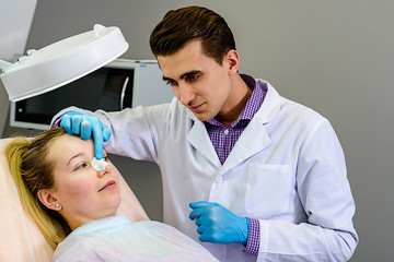 The doctor prepares the patient for surgery.