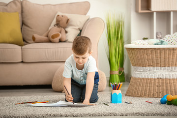 Cute little boy drawing at home
