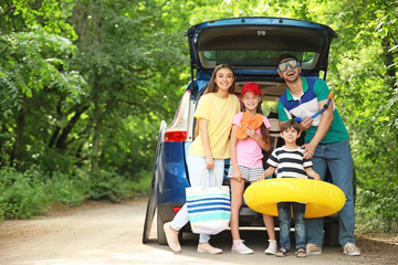 Happy family near car prepared for travelling