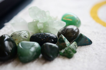 Lush green crystal collection, Green Quartz, Malachite, Peridot, Fluorite, rainforest jasper, and Quantum Quattro. Prosperity and abundance healing crystal collection. White background, bright colors