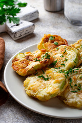 Fried zucchini slices with parsley