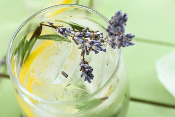 Glass with lavender lemonade on table, closeup