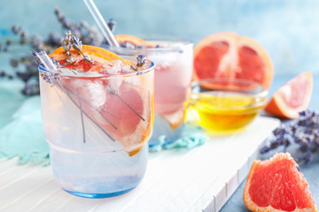 Glass with lavender lemonade on white board, closeup
