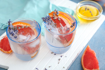 Glasses with lavender lemonade on white board