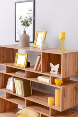 Wooden rack with stylish decor in room