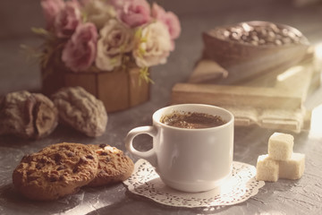 Morning coffee with biscuits and pieces of cane sugar in ray sun. Vintage style