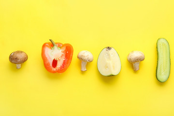 Different fresh vegetables on color background