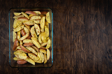 fresh raw potatoes in a baking dish, top view