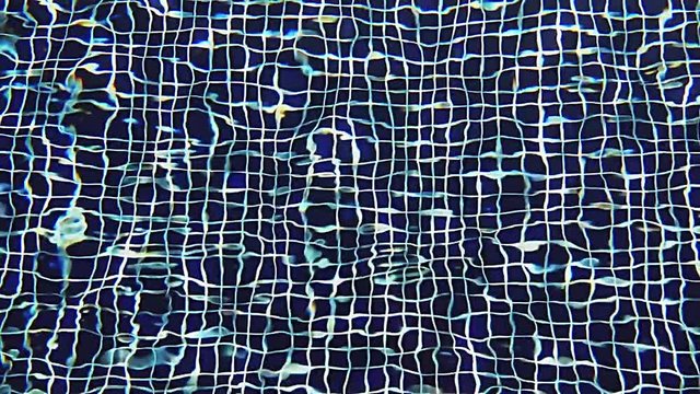 Close-up Shot Of Pool Water features a close-up shot of the clear blue waters of a swimming pool. It appears like the video was taken on a sunny day and the pool looks clean and soothing.