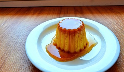 jelly dessert based on milk with caramel syrup on a plate