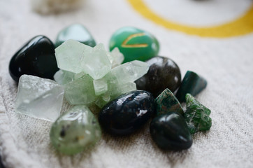 Lush green crystal collection, Green Quartz, Malachite, Peridot, Fluorite, rainforest jasper, and Quantum Quattro. Prosperity and abundance healing crystal collection. White background, bright colors