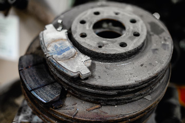 old brake pads on the brake disc with a shallow depth of field