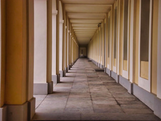 Leaving the terrace of the palace. Open corridor with stone slabs on the floor. Collonada Palace. Background with copyspace.