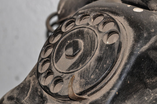 Dirty dusty black old phone in the workshop