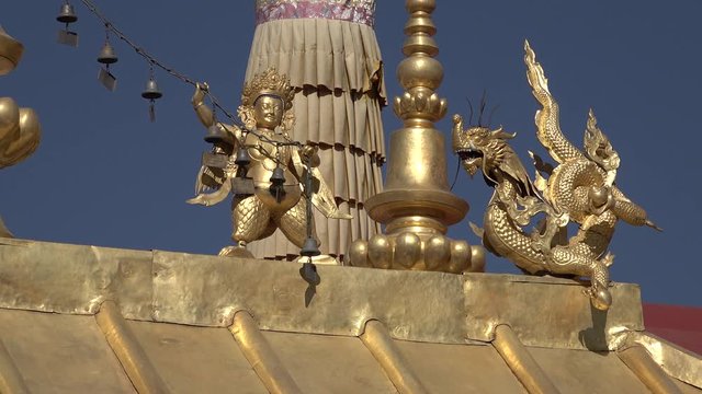 Close-up of golden religious statues on rooftop of Jokhang temple, one of the holiest sites in Lhasa and all Tibet