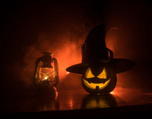 Horror Halloween concept. Burning old oil lamp in forest at night. Night scenery of a nightmare...