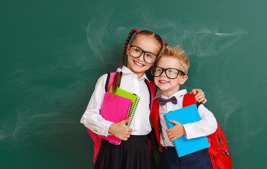 funny group children   schoolboy  and schoolgirl, student boy  and girl about school blackboard