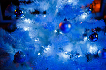 Christmas balls on a white fluffy Christmas tree
