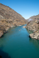 Turquoise water in the river flowing through the narrow gorge