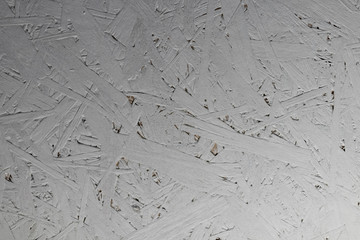 Background texture of OSB 2 fibre pressed wooden sheet material painted grey