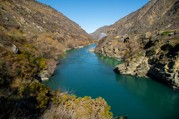 Turquoise water in the river flowing through the narrow gorge