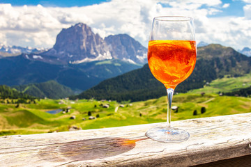 View of the traditional Italian alcoholic drink Aperol Spritz on the background of colorful Italian...