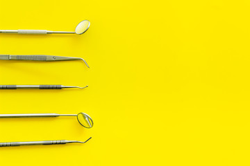 dentist desk with instruments on yellow background top view mockup