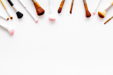 Instruments for make up with brushes on white background top view mock up