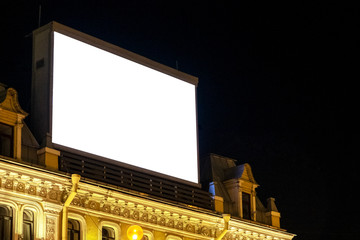 huge Billboard on the building in the night city, night advertising, ready layout for outdoor advertising.