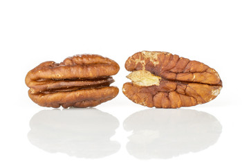 Group of two whole unshelled fresh brown pecan nut half isolated on white background