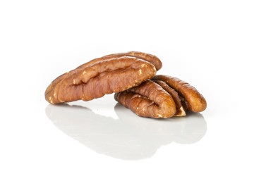 Group of two whole bright fresh brown pecan nut half isolated on white background