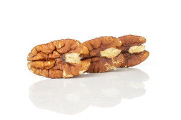 Group of three whole fresh brown pecan nut half in row isolated on white background