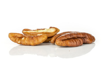 Group of one whole two halves of fresh brown pecan nut half isolated on white background
