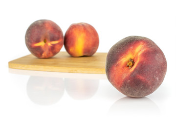 Group of three whole fresh red peach isolated on white background