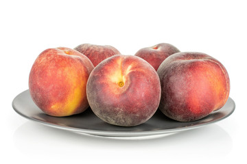 Group of five whole fresh red peach on a gray ceramic plate isolated on white background