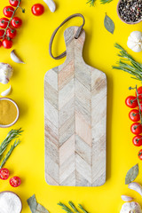 Products frame and cutting board on yellow background top view mockup