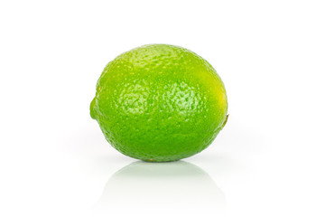One whole fresh green lime isolated on white background