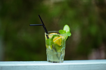 yellow-green refreshing cocktail,lemonade in a glass with tubes