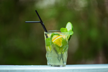 yellow-green refreshing cocktail,lemonade in a glass with tubes
