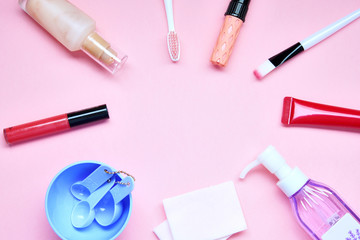 Makeup flatlay, frame layout on pink