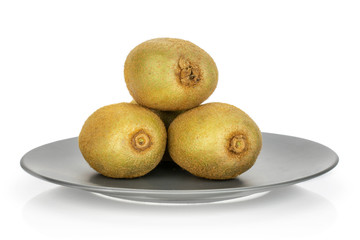 Fototapeta premium Group of three whole fresh green kiwifruit actinidia deliciosa one is on the top of the others on a gray ceramic plate isolated on white background