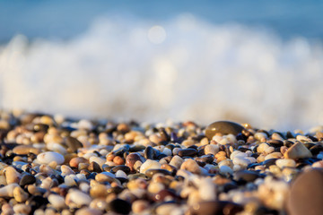 Stones on a background of a sea wave. Background stones and wave. Sea wave. Galichny beach.