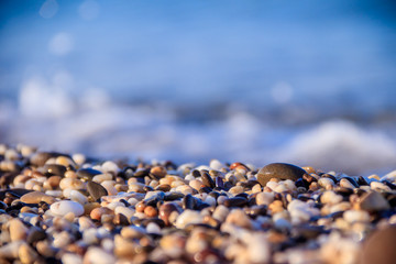 Stones on a background of a sea wave. Background stones and wave. Sea wave. Galichny beach.