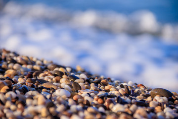Stones on a background of a sea wave. Background stones and wave. Sea wave. Galichny beach.